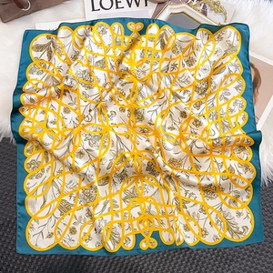 Detail of vintage floral silk square scarf in peacock blue and yellow on white fur