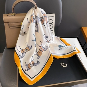 Silk square scarf with equestrian print, orange border and heart brooch on handbag