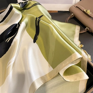 65cm silk square scarf featuring green and black splatter geometric patterns with silky texture