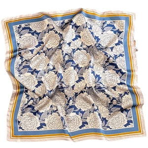 Artistic silk square scarf with blue and yellow floral prints on a white background