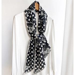 Vintage polka dot and floral print skinny scarf styled on a white shirt collar