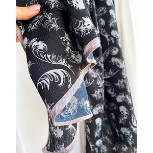 Classic black and white feather print scarf with herringbone texture and contrast piping