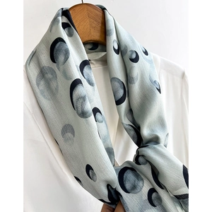 Fashionable silk blend neckerchief with abstract dot pattern on a wooden hanger
