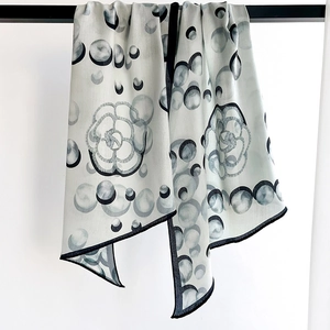 Silk-like fashion scarf with black camellia floral print and polka dots on cream base