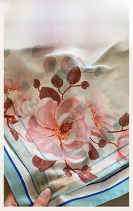 Detailed close-up of floral print silk scarf featuring fine machine hemmed edge quality