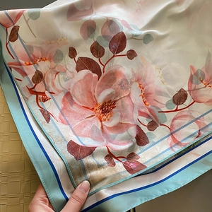 Elegant silk-like floral scarf with soft pink flowers and blue striped edge detailing