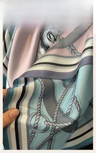 Close-up of vintage chain print silk scarf showing exquisite machine-rolled edge stitching