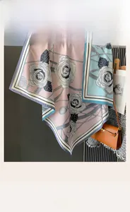 Detailed close-up of double-sided silk scarf with rose print and draped texture