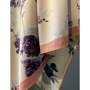 Elegant beige silk scarf with purple floral print and pink hemmed edges
