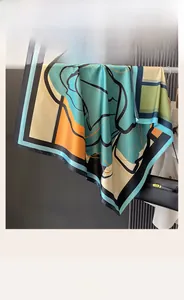 Detail view of double-sided silk shawl with geometric patterns and vibrant color blocking