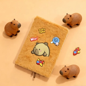 Detail of plush brown Capybara notebook featuring soft faux fur texture and cute cartoon patches