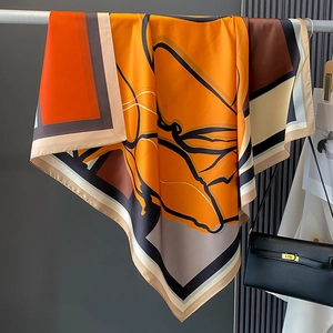 Detail of luxury silk scarf with modern abstract orange geometric floral pattern