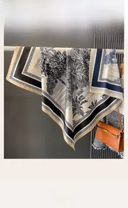Detail of double-sided silk scarf with tropical palm prints and contrasting borders
