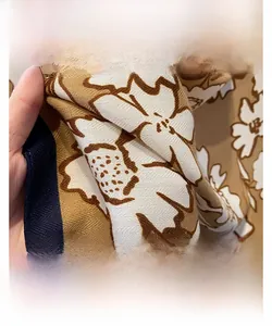 Close-up of vintage floral print scarf showing twill weave and fine overlock stitching