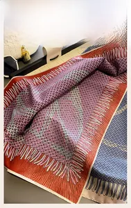 Detail of geometric pattern silk scarf with machine-rolled edges and luxury accessories