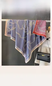 Detail of double-sided silk-like square scarf with geometric print and fine fringe edges