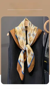 Close-up of geometric pattern silk scarf with mustard yellow and blue accents