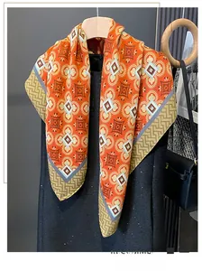 Detailed close-up of retro orange-red bohemian scarf hanging with intricate patterns