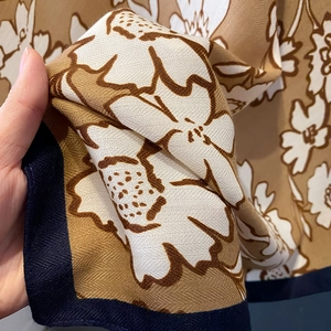 Detailed close-up of high-quality floral printed shawl with twill texture and blue borders