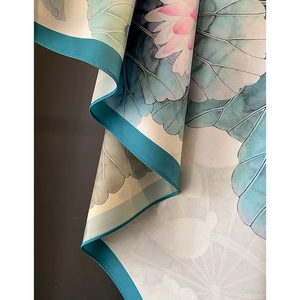 Silk scarf featuring elegant double-sided lotus flower print and delicate cyan edges