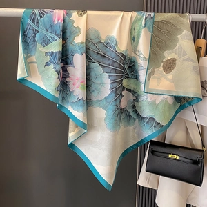 Silk-like 90cm square scarf with lotus print elegantly draped over a hanging rod