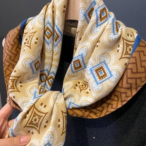 Close-up of vintage geometric print silk scarf showing lightweight drape and soft texture