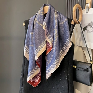 Elegant geometric silk-like square scarf with blue grid pattern and orange accents