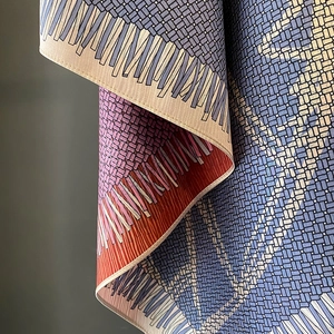 Detail of trompe-l'œil woven print on silk-like scarf with hand-rolled edges