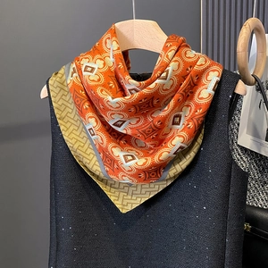 Detailed texture of silk scarf with vintage geometric patterns in gold and blue