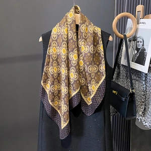 Detail showing vintage geometric pattern scarf with silk texture and drape on clothing