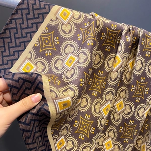 Close-up of vintage floral scarf fabric with retro clover patterns and soft texture