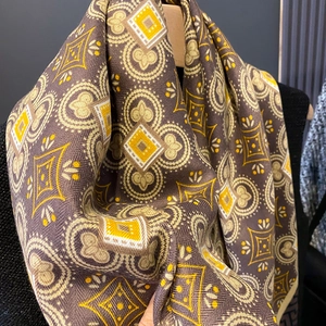Close-up detail of vintage geometric diamond pattern on thick warm knit scarf