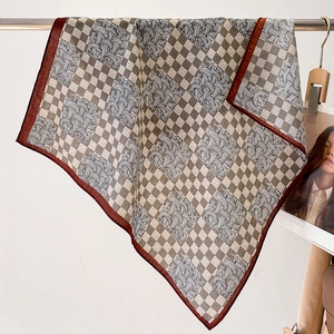 Detail showing checkered patterns and abstract lines on a soft neck scarf decoration