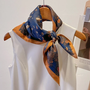 Elegant navy and orange floral silk scarf styled on a hanger for professional outfits