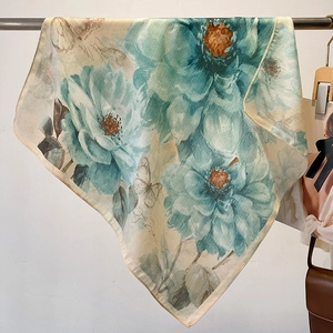 Elegant cotton-linen scarf with blue floral and butterfly print hanging on a rack