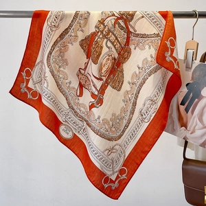 Detail of vintage equestrian silk scarf draped elegantly with horse bridle print