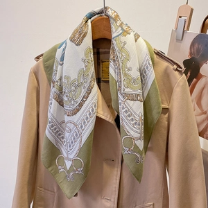 Elegant retro silk-feel square scarf with baroque patterns on a trench coat