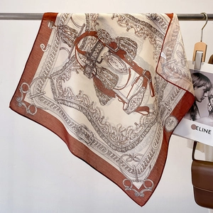 Detailed view of silk square scarf featuring vintage equestrian print and rolled edges