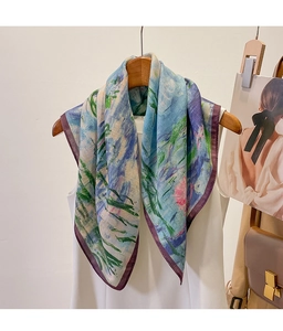 Detailed texture of an impressionist floral silk scarf with hand-rolled purple edges