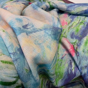 Macro detail of herringbone texture and impressionist floral oil painting pattern on scarf