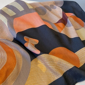 Elegant geometric silk scarf with navy blue and orange abstract pattern and herringbone weave