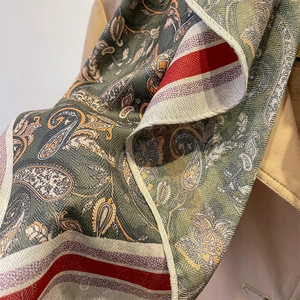 Vintage paisley pattern scarf in dark green and brick red over a khaki trench coat