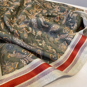Vintage paisley silk scarf in dark green and orange gold with striped hem and weave detail