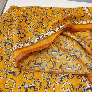 Elegant orange silk-feel scarf with geometric equestrian horsebit and chain print pattern