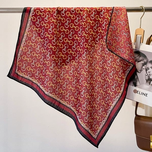 Detailed view of red cotton-linen square scarf with vintage horsebit chain patterns