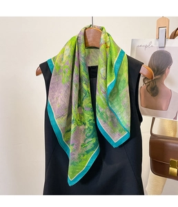 Artistic oil painting style silk scarf draped on a hanger showing vibrant green details