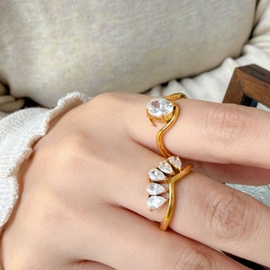 Detailed view of two 18K gold plated rings with oval and pear cut cubic zirconia stones