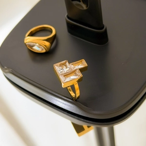 Macro detail of 18K gold-plated oval zircon and T-shaped geometric zircon ring set