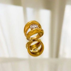 Macro view of gold plated dual band ring featuring a centered oval cubic zirconia stone