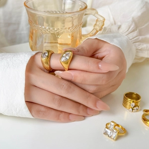 Elegant 18K gold-plated titanium steel rings featuring oval zircon and layered crystals